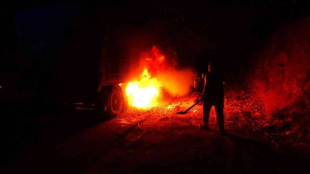 Alev alan tırın lastiğini kürekle toprak atıp söndürmeye çalıştı