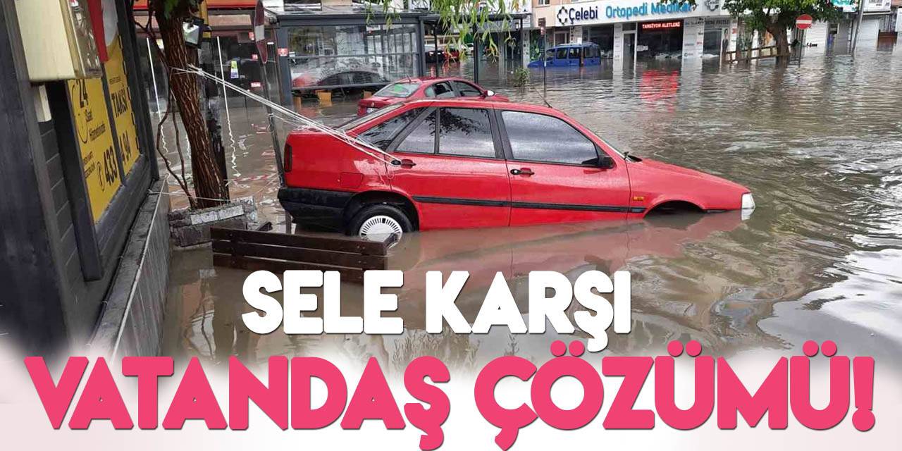 Otomobilini sel sularına kapılmasın diye ağaca bağladı!