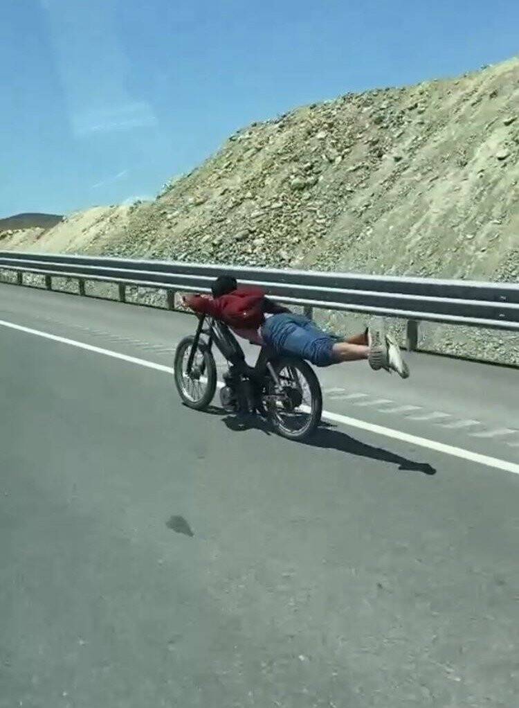 Motosikletin üstüne yatan sürücünün tehlikeli yolculuğu kamerada