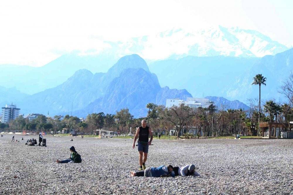 Türkiye donarken Antalya’da  güneşi gören sahile geldi