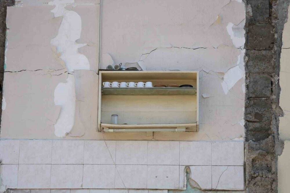 Depremde yerle bir olan binada dikkat çeken görüntü: Raftaki fincanlar olduğu gibi kaldı